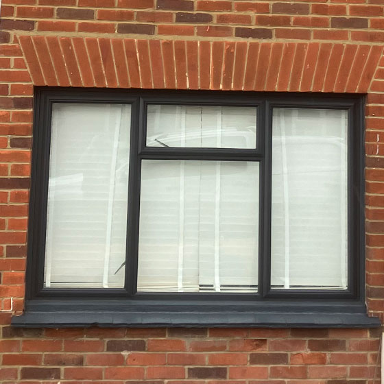 A newly painted dark grey window frame